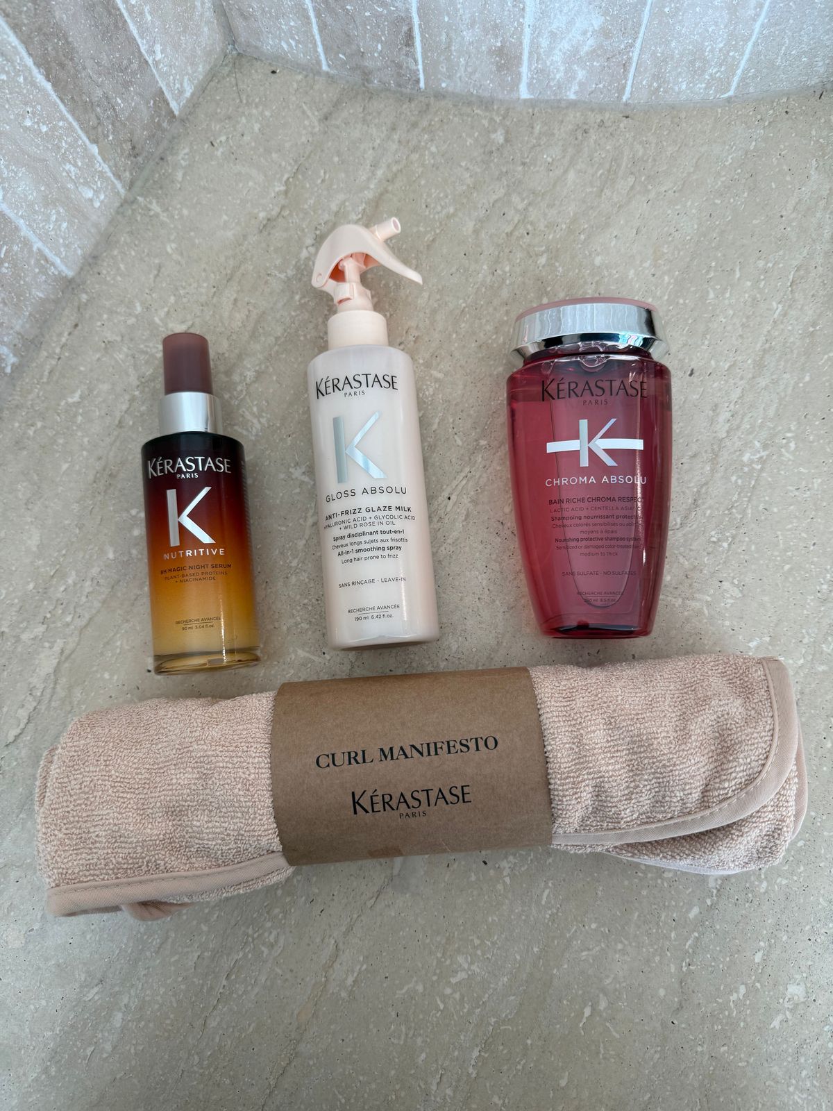 the contents of a personal care bag laid out on the floor