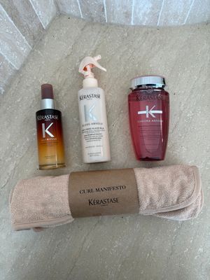 the contents of a personal care bag laid out on the floor