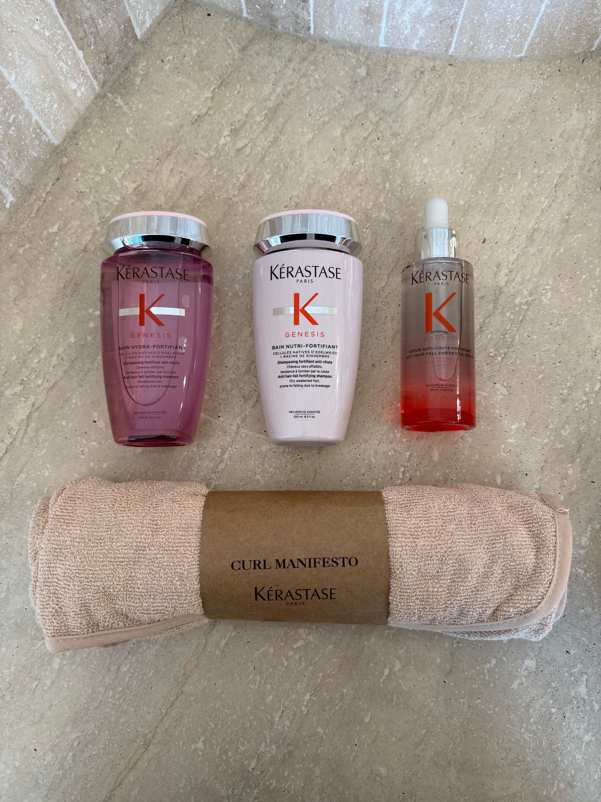 three bottles of kerastan and a towel on the floor