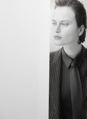 a black and white photo of a woman in a suit