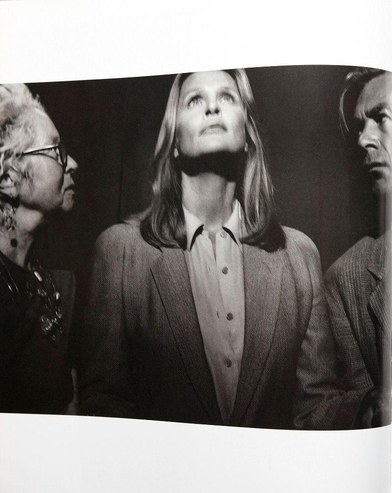 a black and white photo of a woman and two men