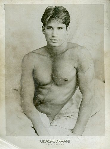 a black and white photo of a shirtless man