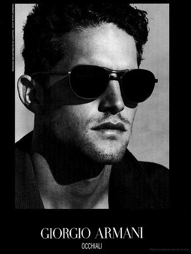 a black and white photo of a man wearing sunglasses