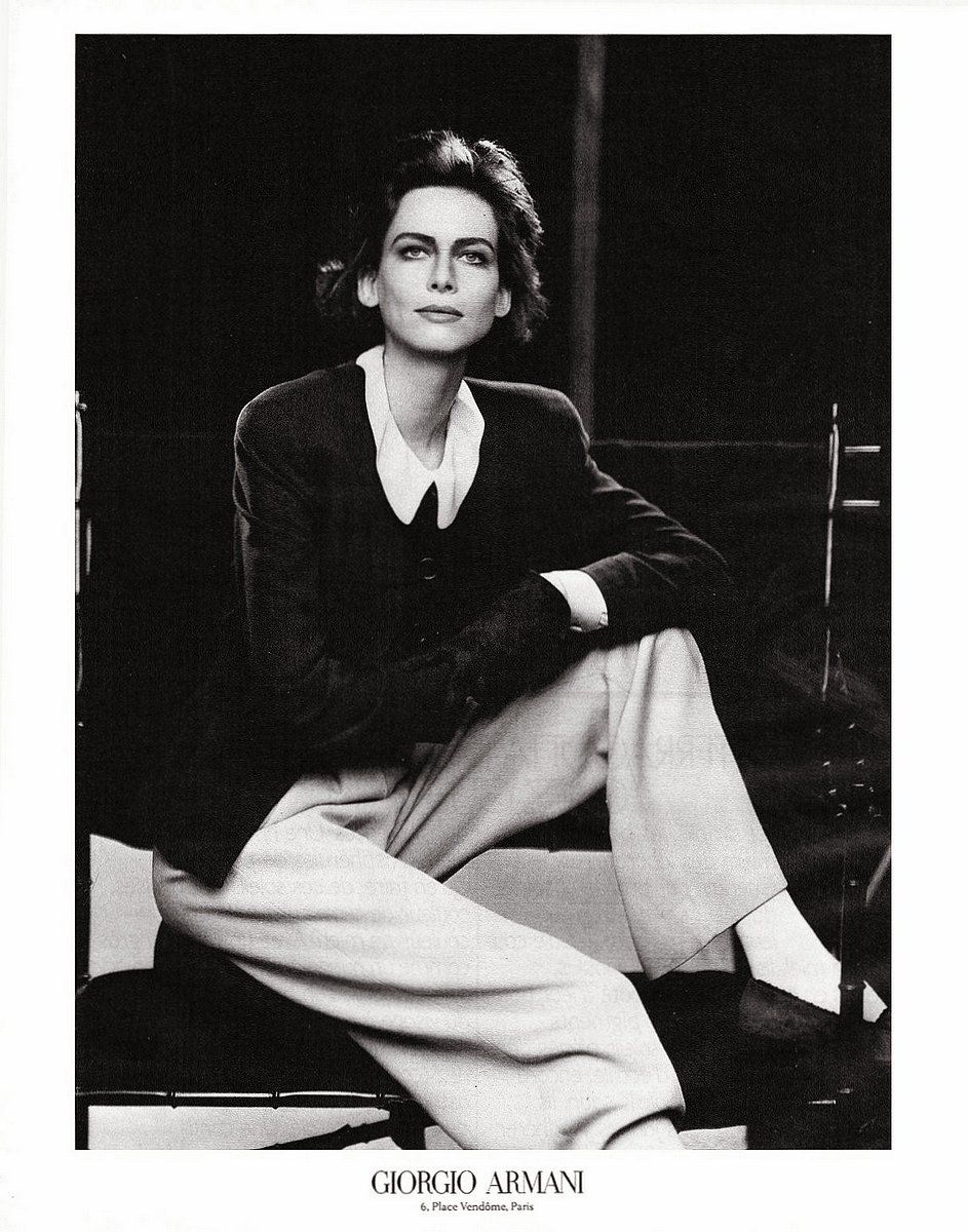 a black and white photo of a woman sitting on a chair