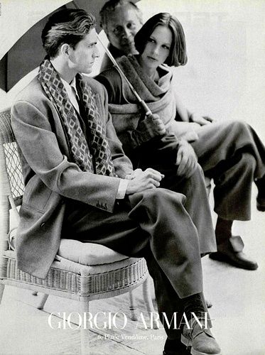 a black and white photo of three people sitting on a chair