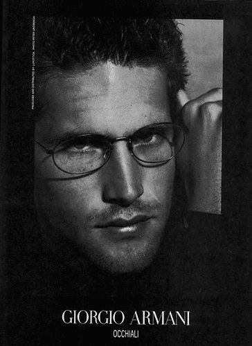 a black and white photo of a man wearing glasses