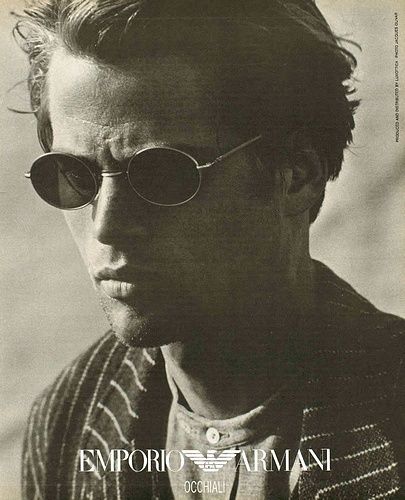 a man wearing sunglasses and a striped jacket