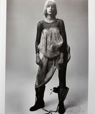 a black and white photo of a woman in a dress