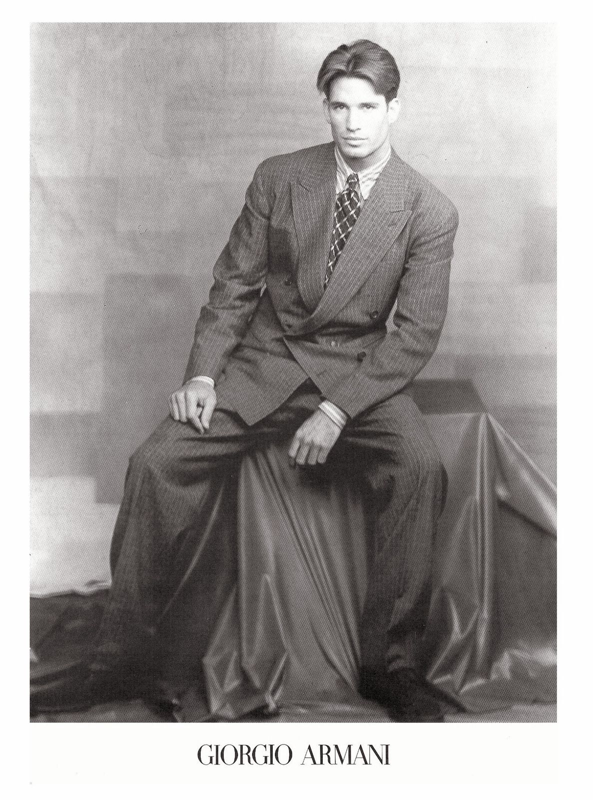 a black and white photo of a man in a suit