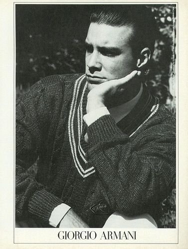 a black and white photo of a man in a sweater