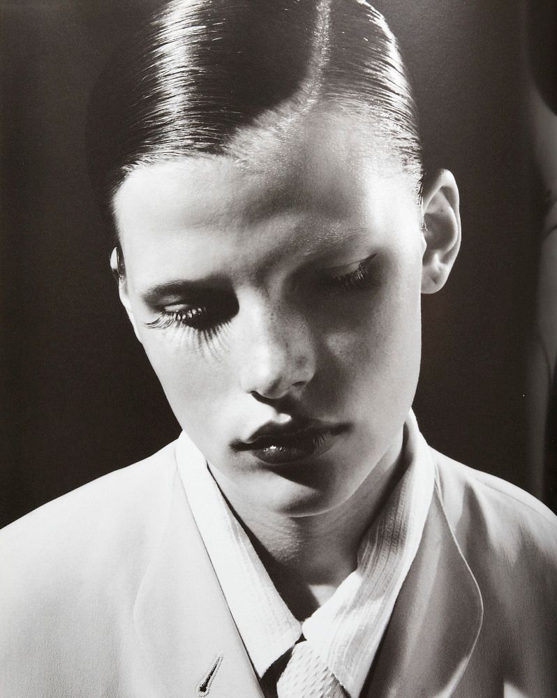 a black and white photo of a man with fake eyelashes