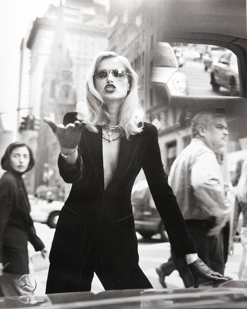 a black and white photo of a woman in a suit