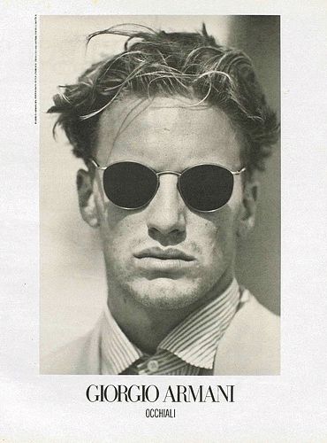 a black and white photo of a man wearing sunglasses