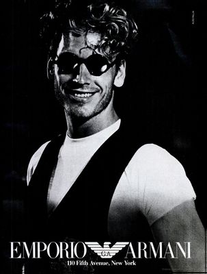 a man wearing sunglasses and a white shirt