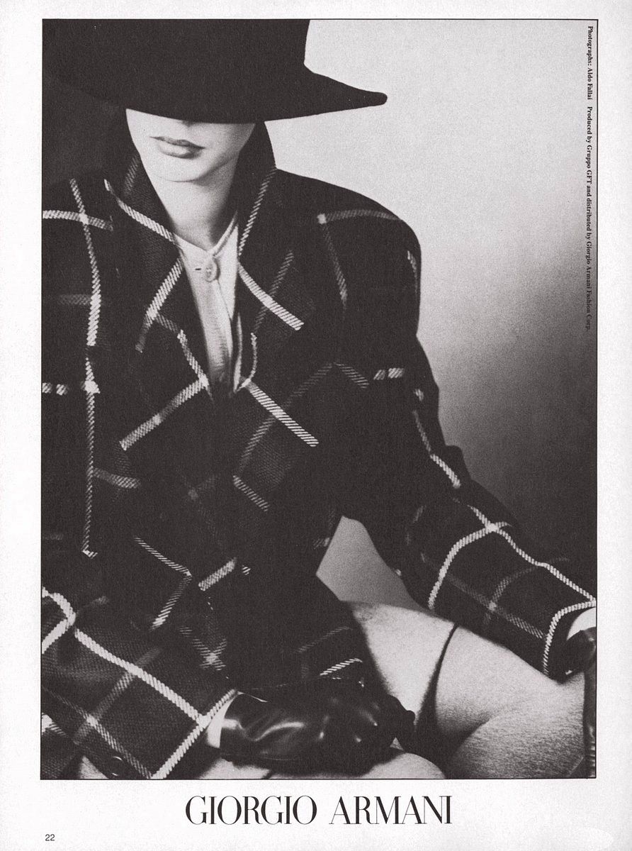 a woman in a plaid shirt and black hat