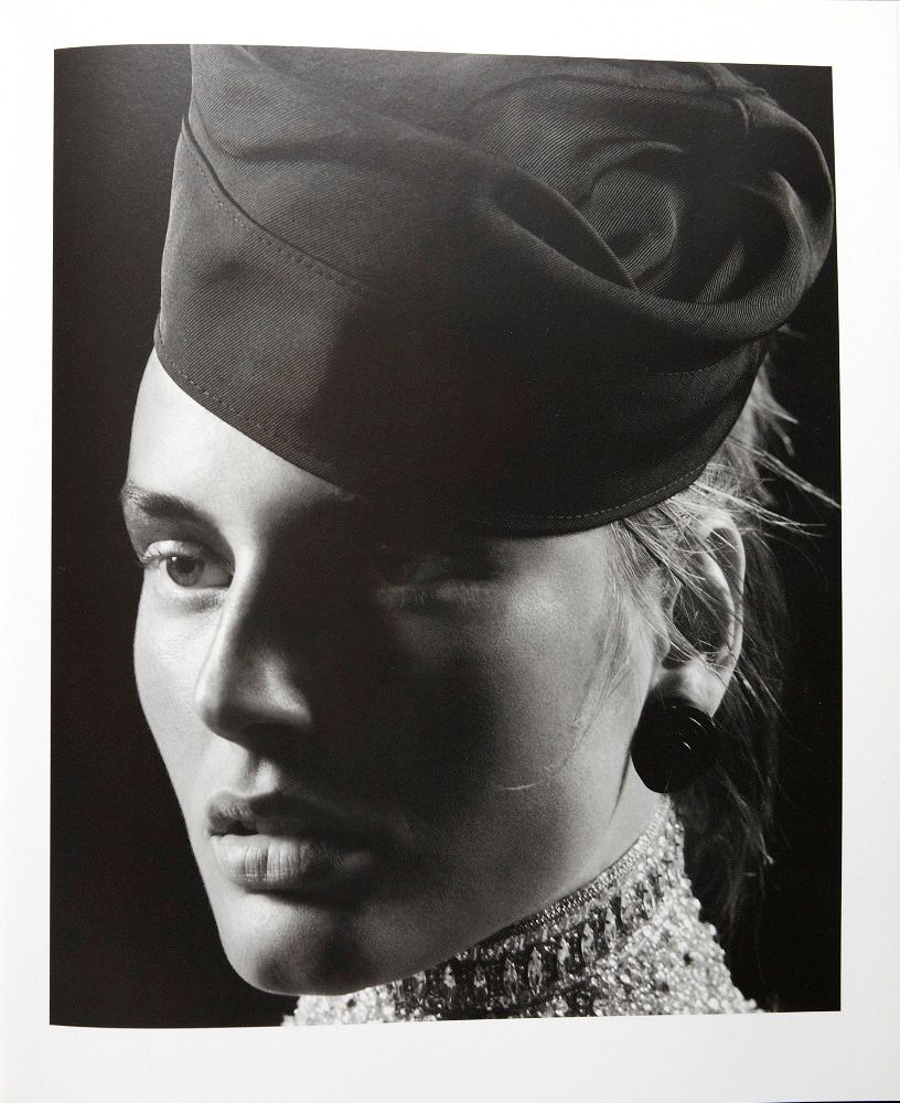 a black and white photo of a woman wearing a hat