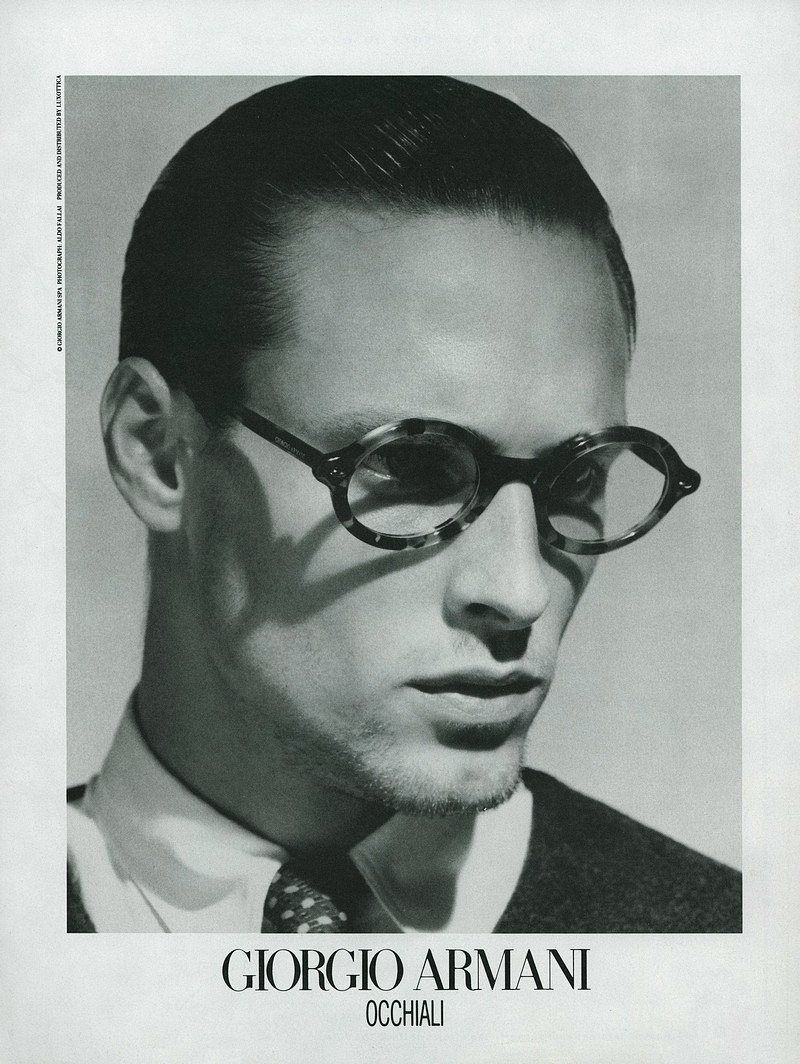 a man wearing glasses and a suit and tie