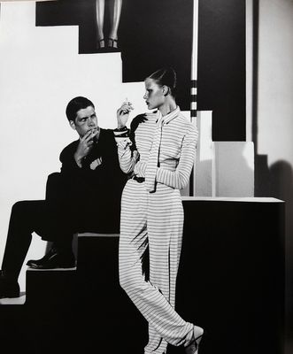 a black and white photo of a man smoking a cigarette