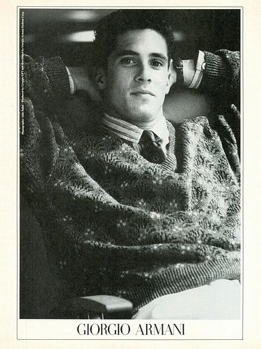 a black and white photo of a man wrapped in a blanket