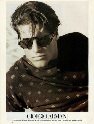 a man wearing sunglasses and a sweater