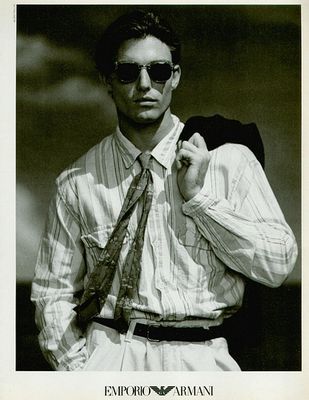 a man in a shirt and tie posing for a picture