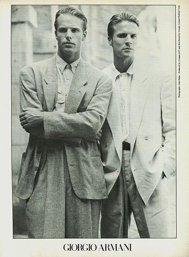 a black and white photo of two men in suits