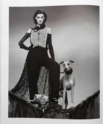 a black and white photo of a woman and a dog