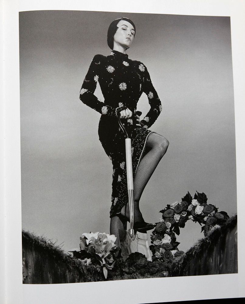 a black and white photo of a woman in a dress