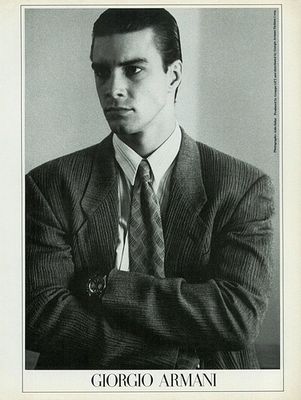 a black and white photo of a man in a suit