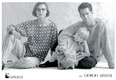 a black and white photo of three people and a baby