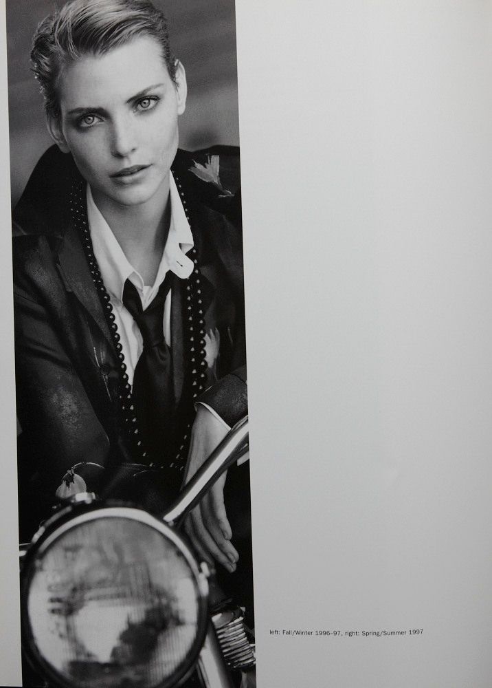 a black and white photo of a woman on a motorcycle