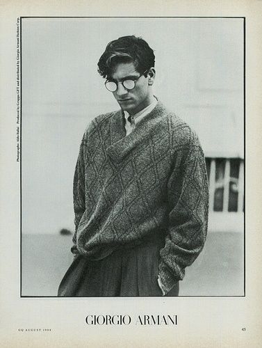 a black and white photo of a man wearing a sweater