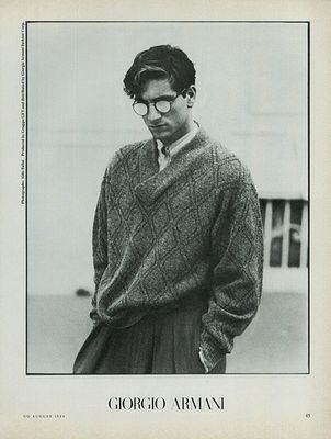 a black and white photo of a man wearing a sweater