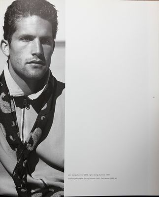 a black and white photo of a man wearing a tie