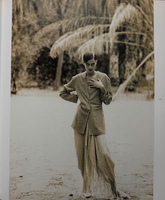 a black and white photo of a woman in a skirt