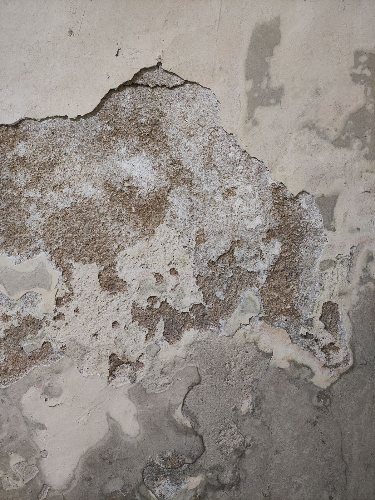 a close up of a wall with peeling paint