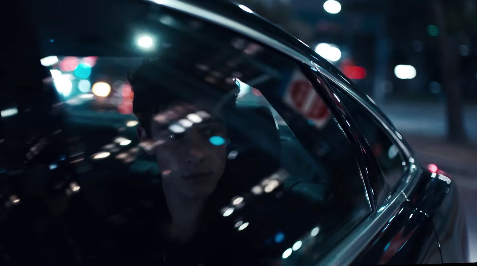 a woman is sitting in a car at night