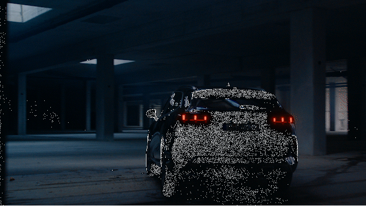 a car parked in a parking garage at night