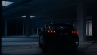 a car parked in a parking garage at night