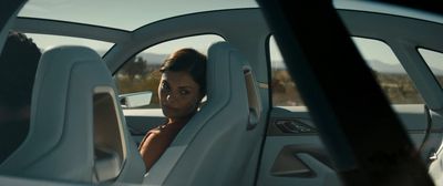 a woman sitting in a car with her head out the window