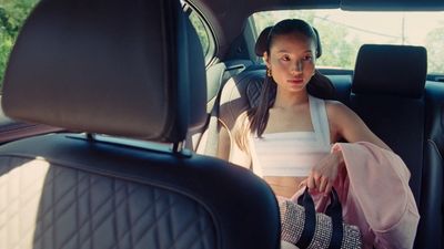 a woman sitting in the back seat of a car