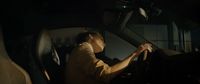 a person sitting in a car with a steering wheel