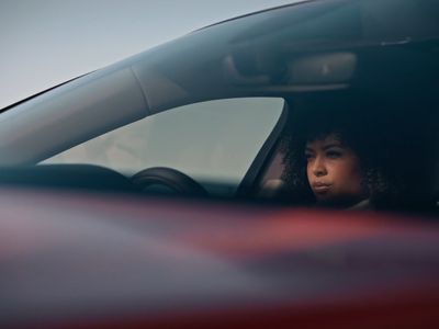 a woman sitting in a car with her head out the window