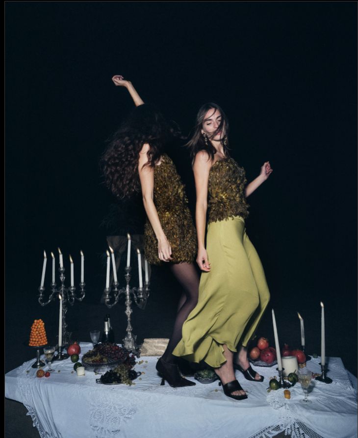 two women standing next to each other on a table