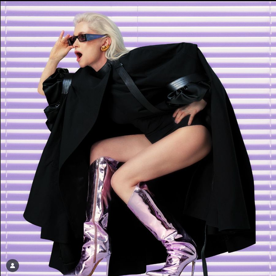 a woman in a black coat and boots