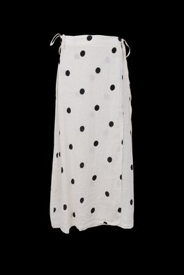 a white skirt with black dots on it