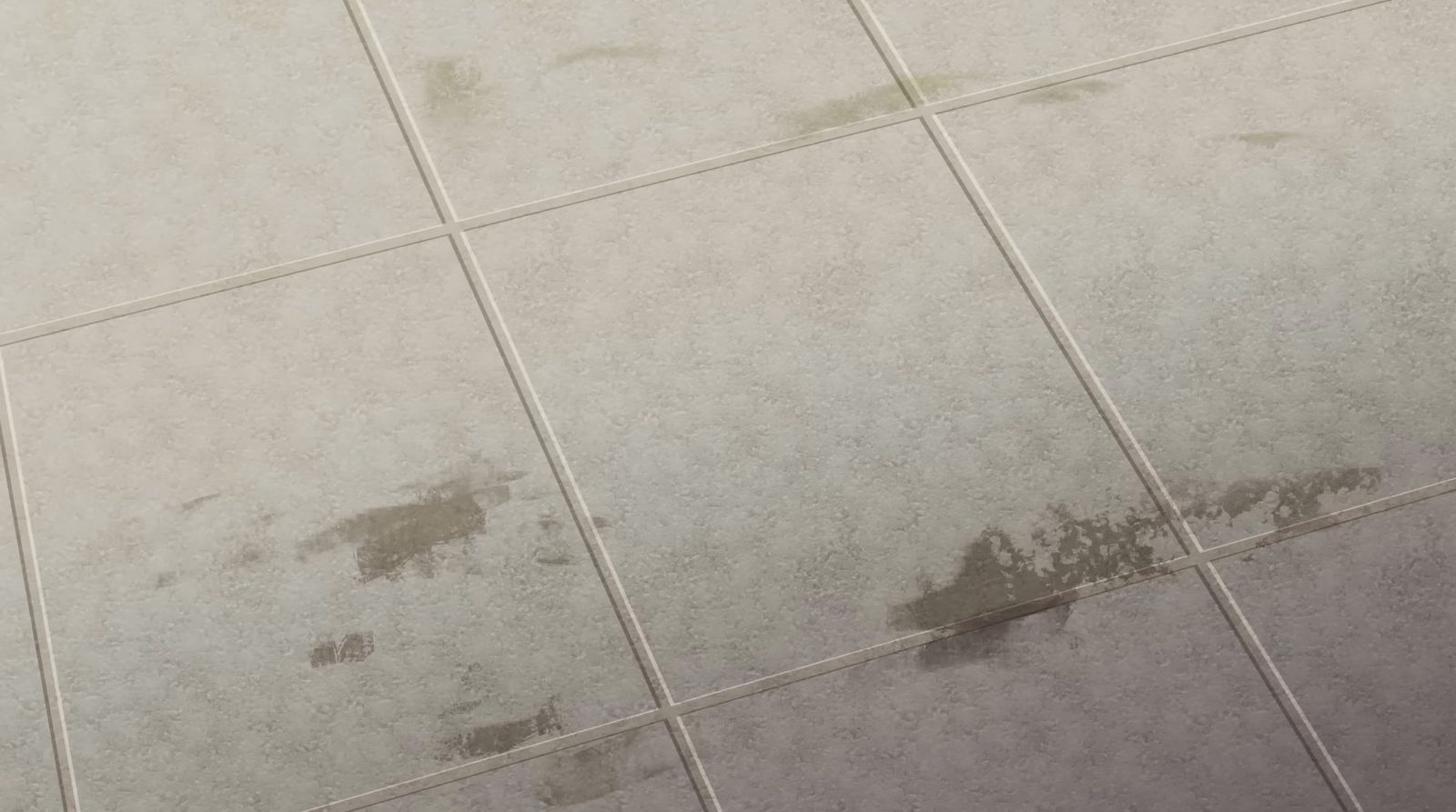 a white tiled floor with brown stains on it