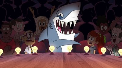 a group of people standing around a table with a shark on it