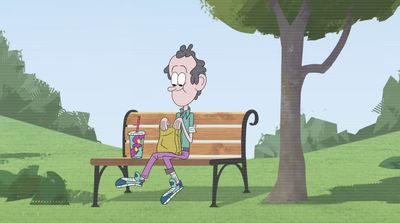 a man sitting on a bench in a park