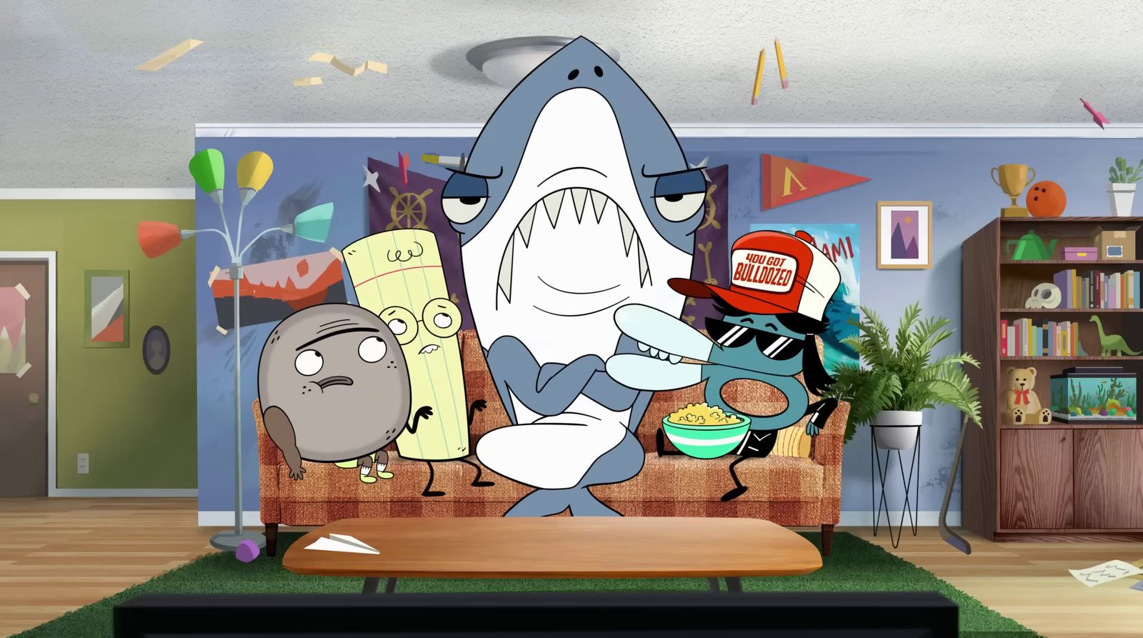 a living room with a cartoon shark on the wall